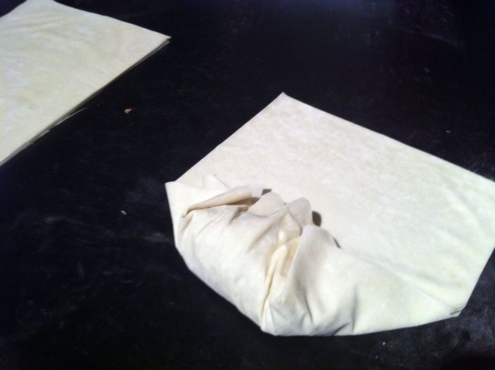 Take the left and right corners of the previous fold and over lap it on top. It's very similar to wrapping a sandwich.