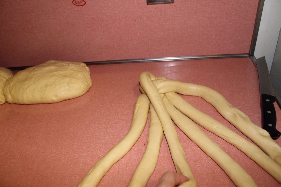 Take the left outer strand and cross it to the middle of the 4 innermost strands