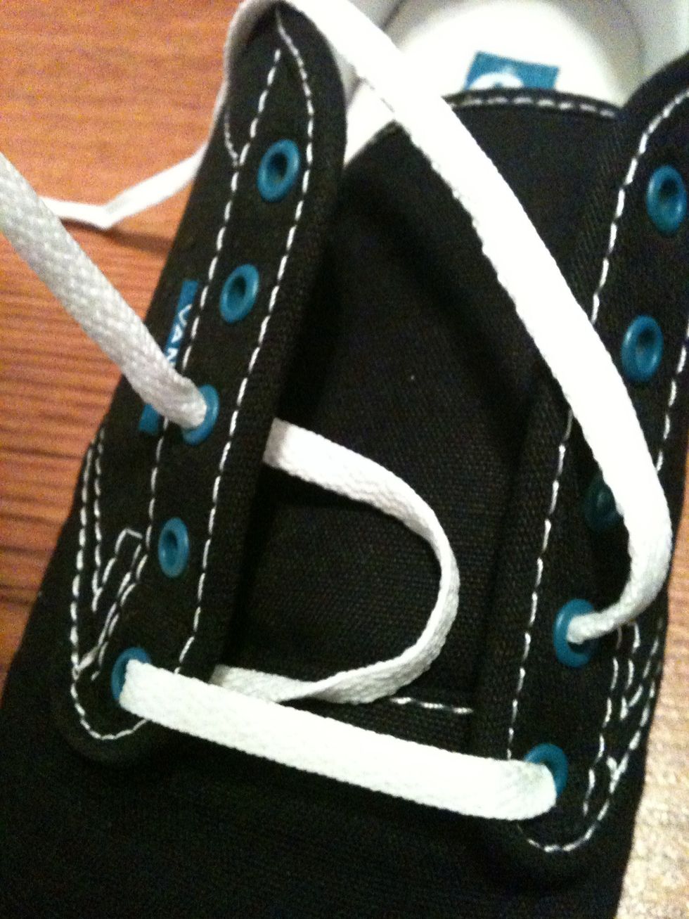 Take the left string and pull it through the bottom of the third eye on the left side