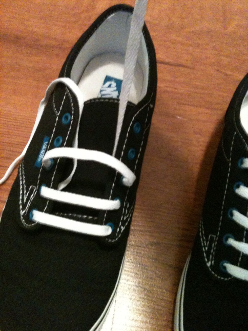 Take the left string and pull it through the top of the third eye on the right side