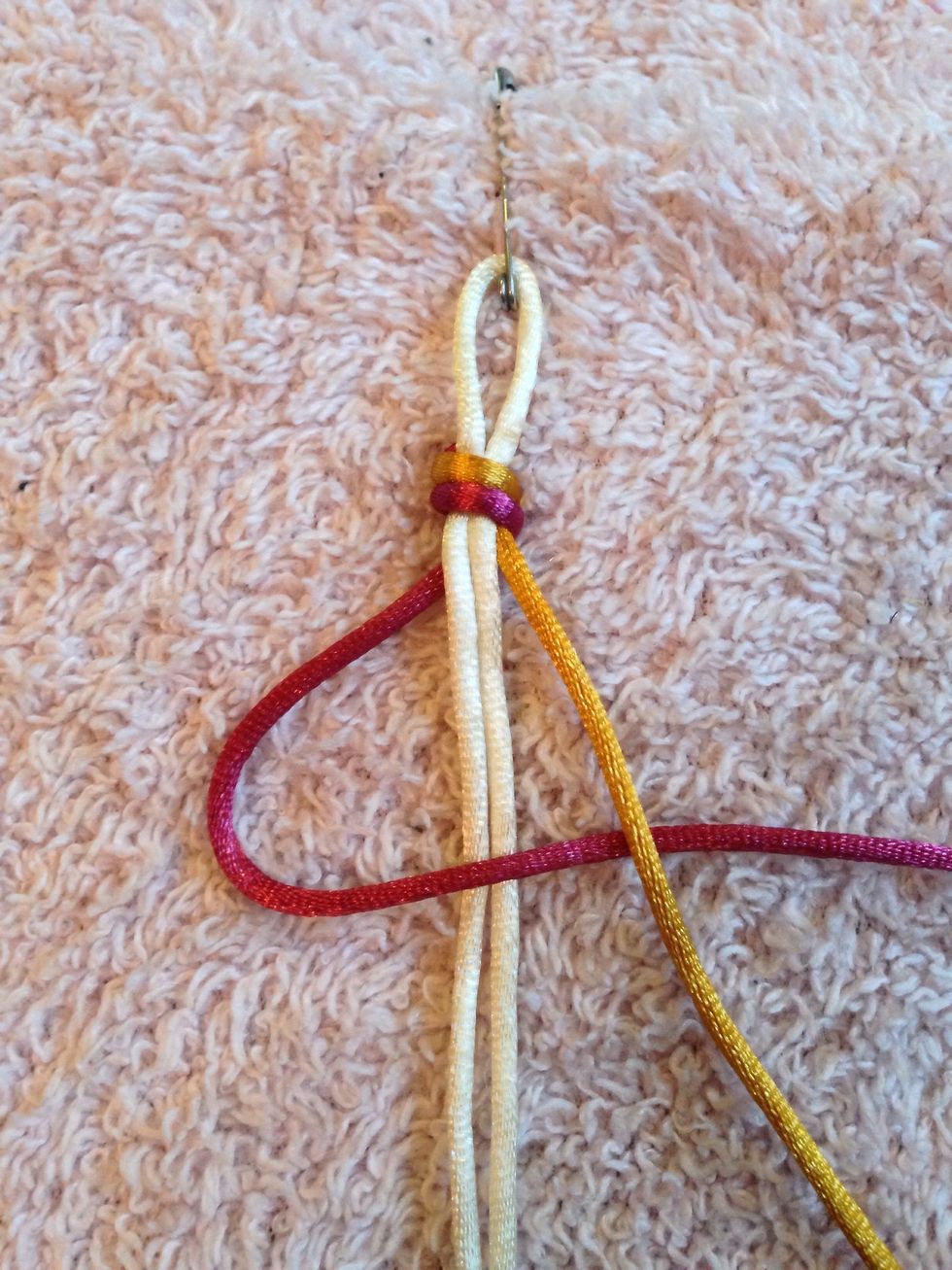 Take the LEFT thread and put it OVER the core threads and UNDER the RIGHT thread.