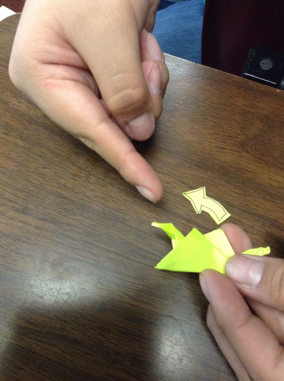 Take the leg where the triangles point down to and take a piece of the head and push it down.