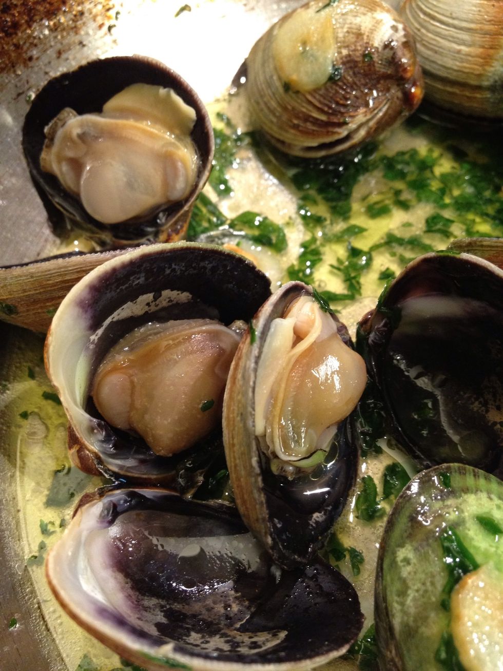 Take the lid off. Depending on the clams it shouldn't take more than one minute or two. They should look shiny. Feel free to take out one by one as soon as they open