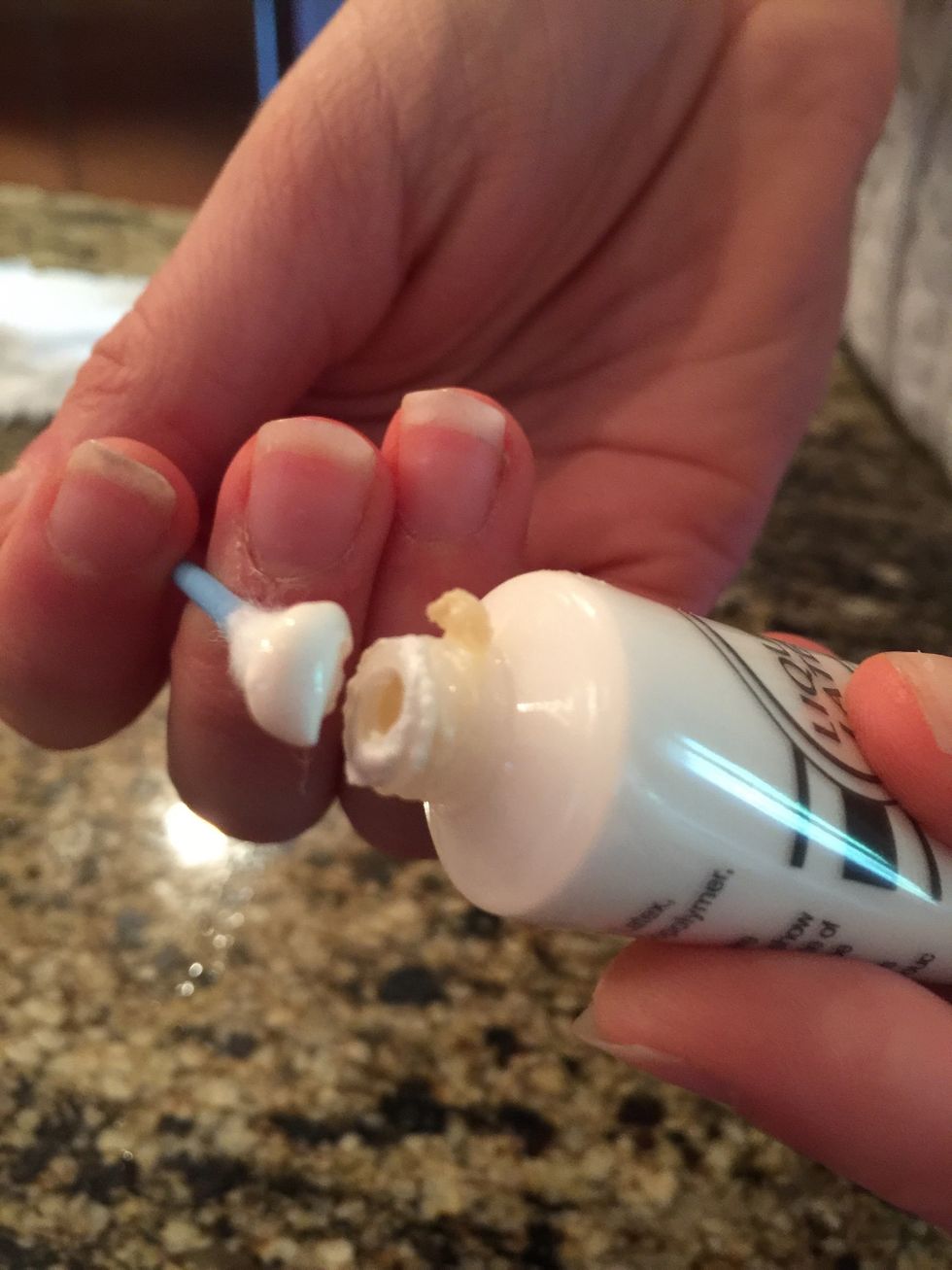 Take the liquid latex, and apply it on a cotton swab.