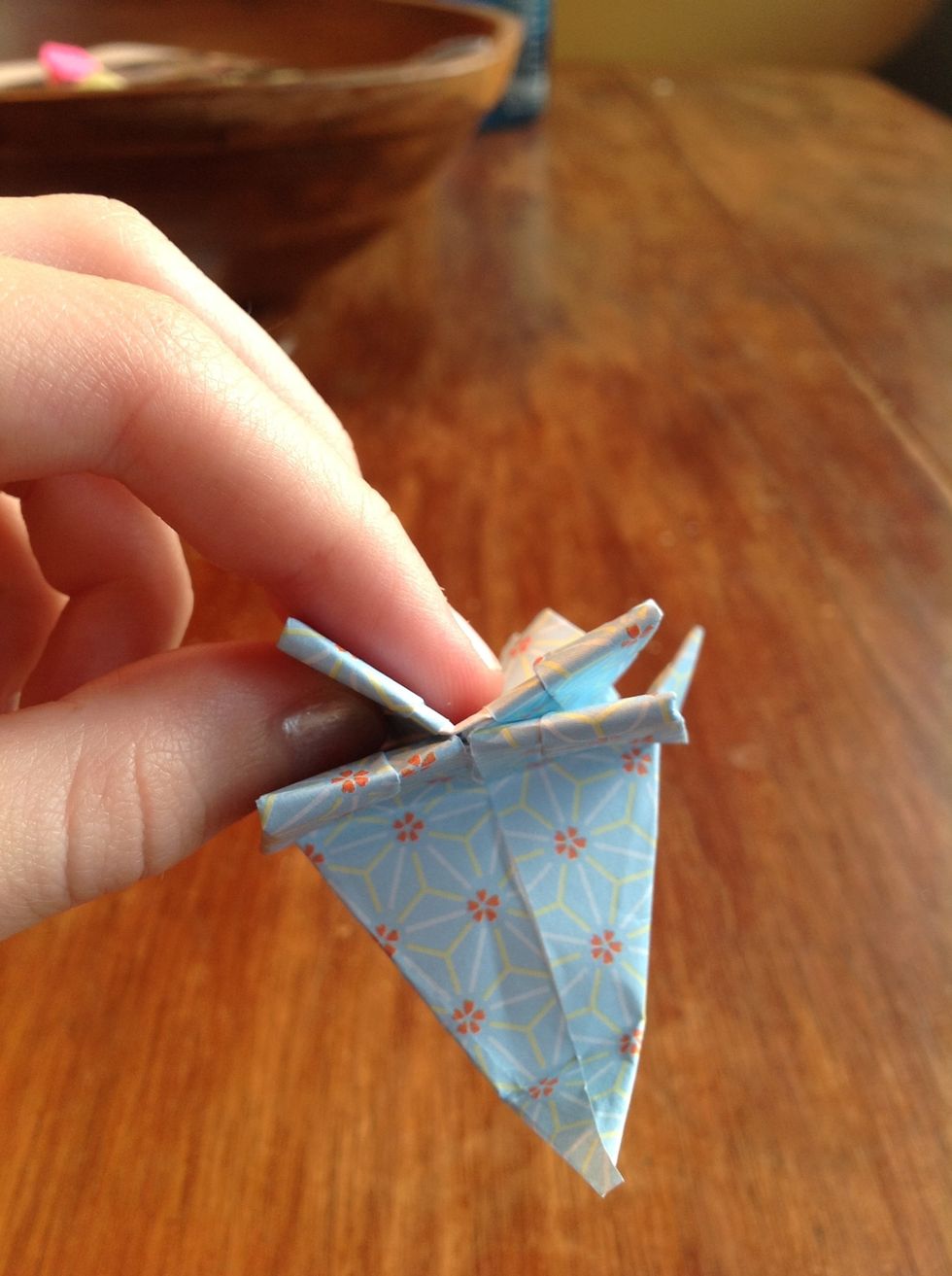 Take the little hole in the bottom and blow into it to puff the body out