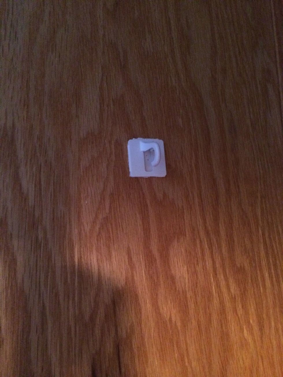 Take the little plastic hook and stick it on the back of the kitchen cabinet making sure it's on the center. I found this little cheap hook at my local dollar store.\ud83d\udc4d