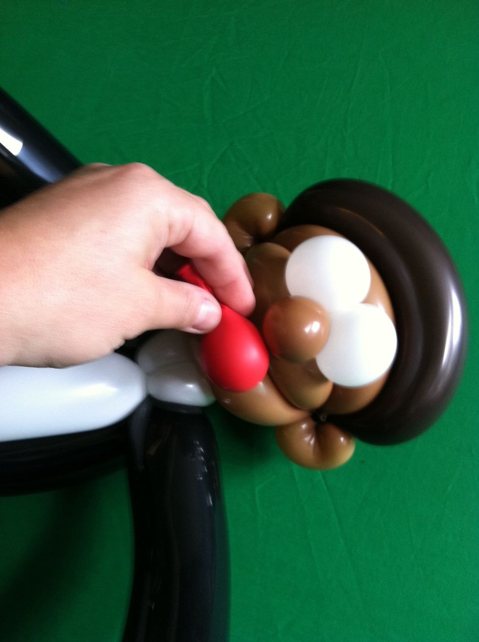 Take the little red balloon and stuff it in his mouth