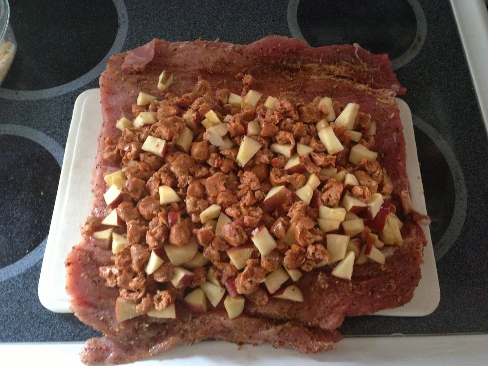 Take the loin back out of the fridge and lay it flat, cut side up. Spread out your sausage and apples evenly, leave a little space along the bottom and sides, and a little more across the top.