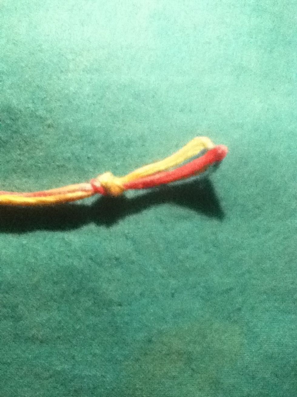 Take the loop at the top and make a knot