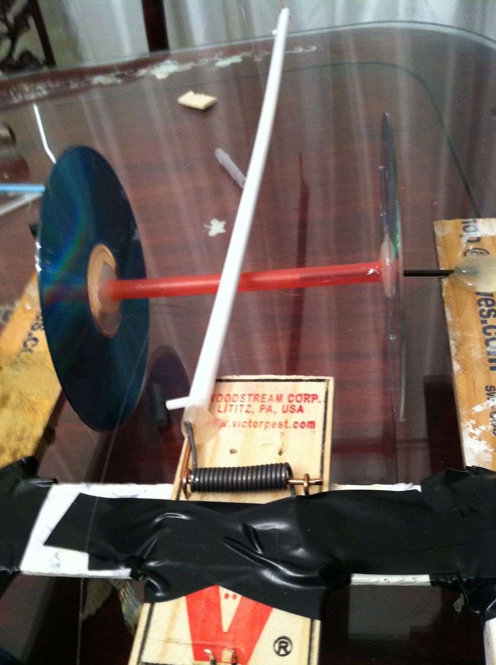 Take the lower portion of the hanger make sure both side have clear whole after you have cut them so you can slip the remaining snapping portion of the mousetrap inside now glue so it doesn't come out