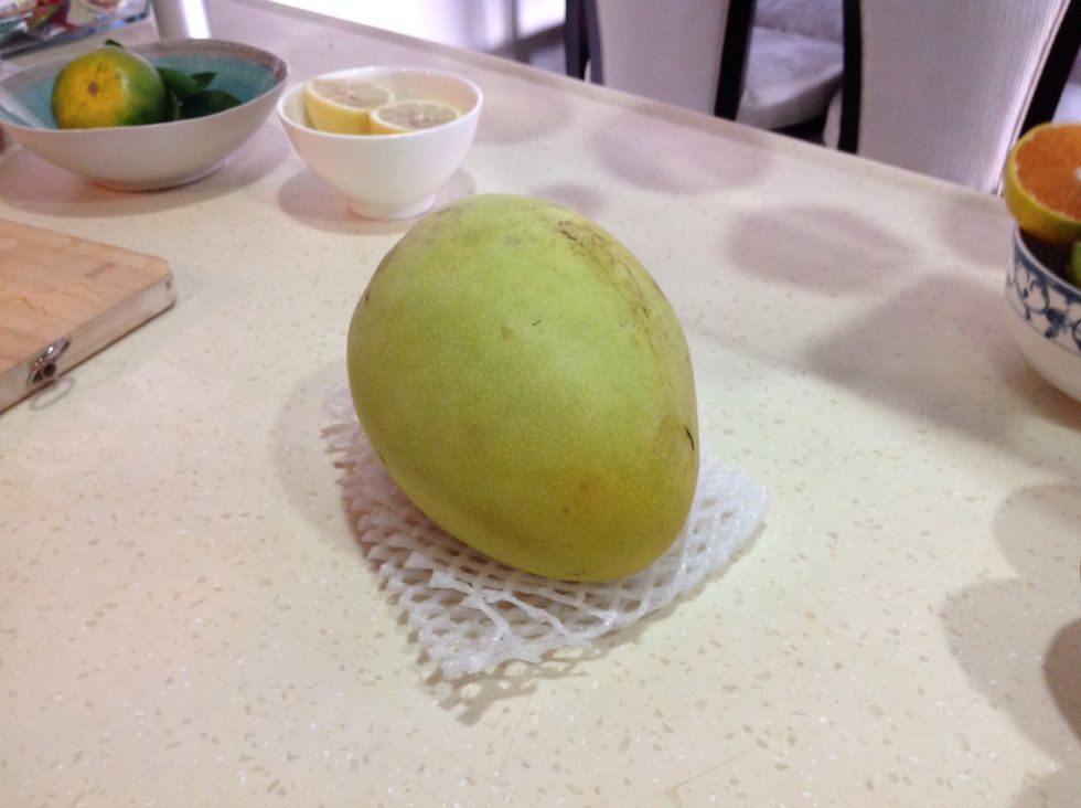 Take the mango and peel it.