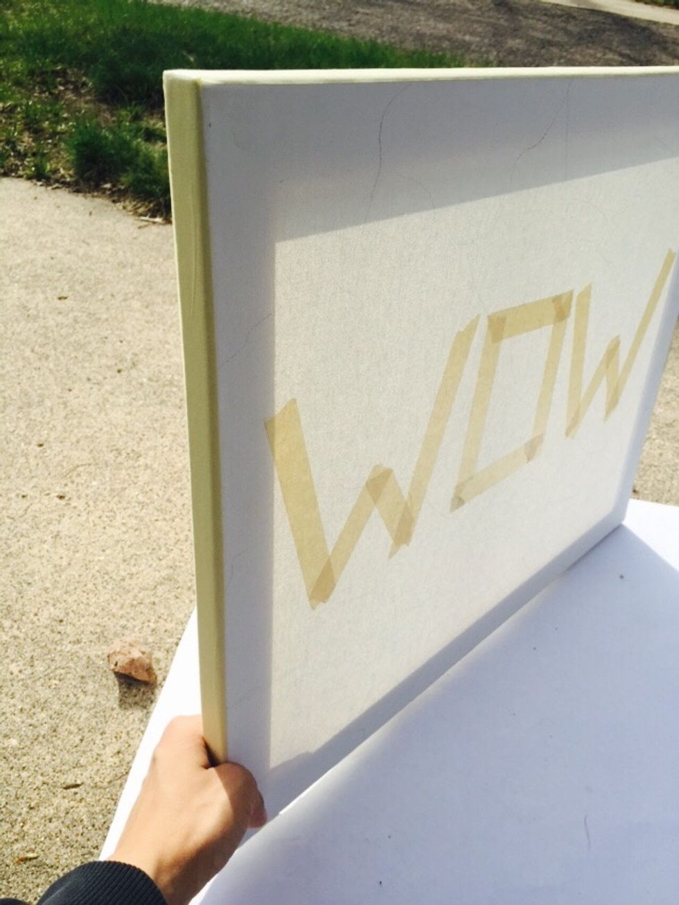 Take the masking tape again and place it all along the edges of the canvas.