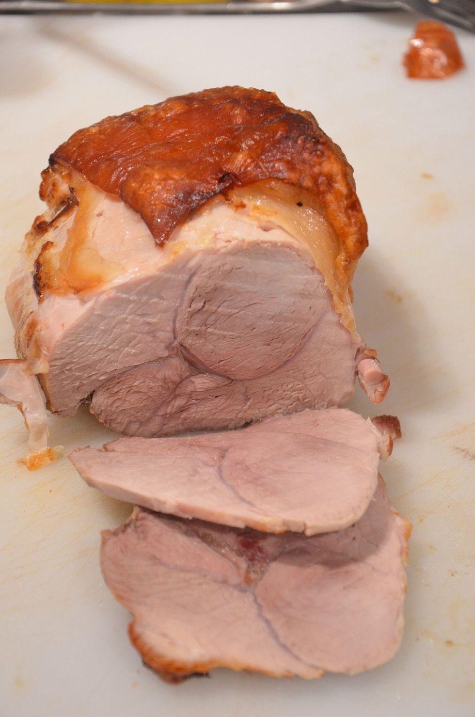 Take the meat out of the oven and cut the slices. The pork rind is very hard to cut therefore its better to remove it ( and just eat it right away)