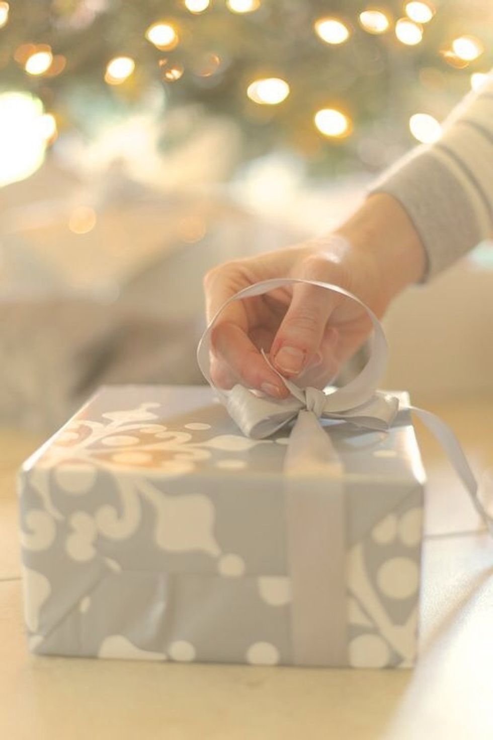 Take the mid-ribbon piece that is connecting the two ears and loosen. Pick up the long piece of leftover ribbon and loop it through the new hole you just made so it goes through the opposing side