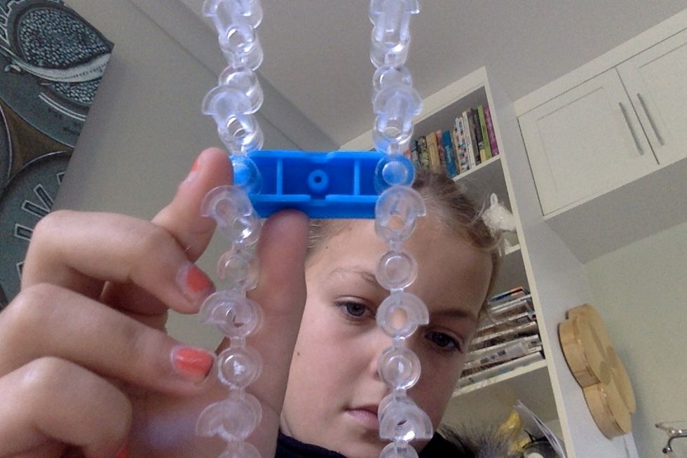 Take the middle bar out of your loom.