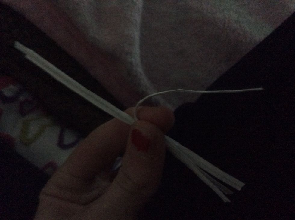 Take the middle tie and bend its top part out of the bunch.