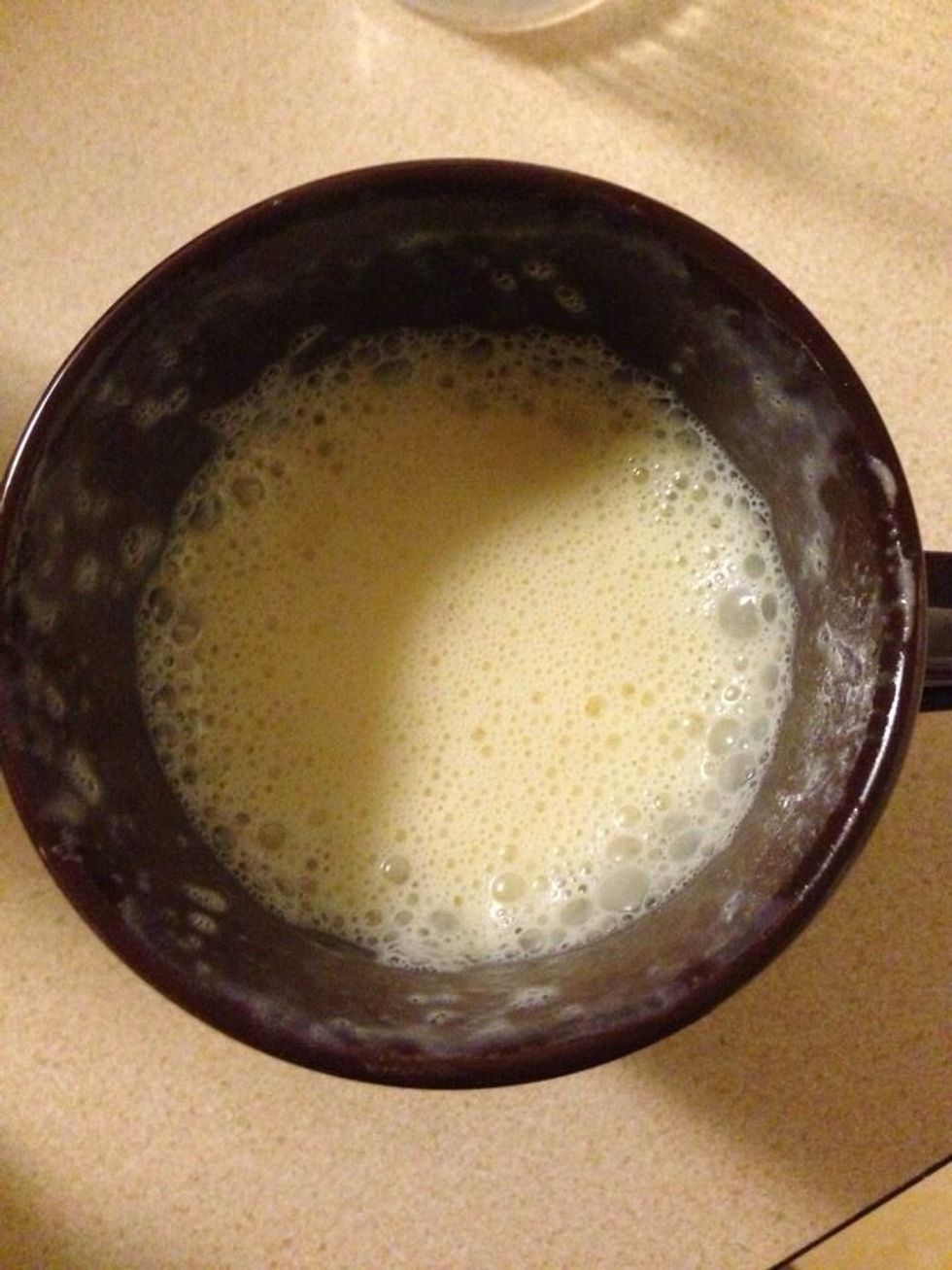 Take the mug out the microwave and stir it