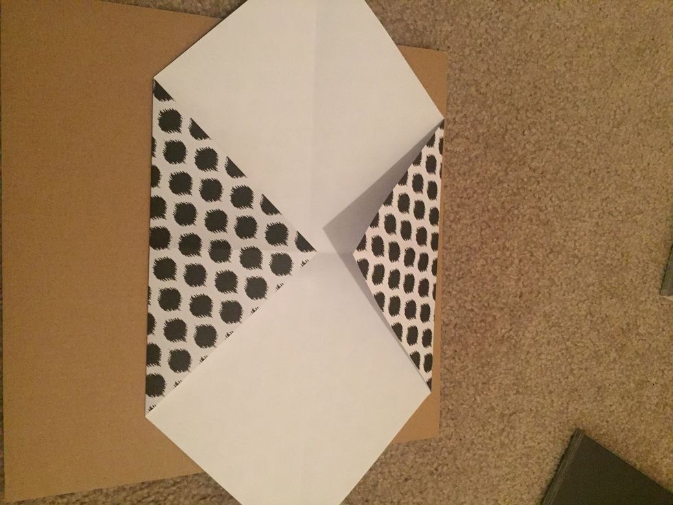 Take the opposite corner & fold towards the center.