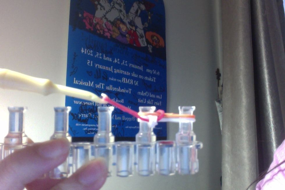 Take the other bottom band and loop it over.