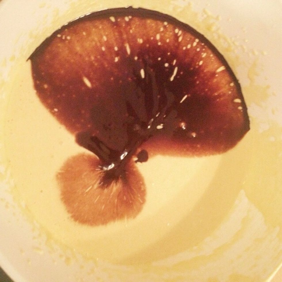 Take the other bowl with whisked sugar and yolks and pour in the now cold but still melted chocolate and butter. Whisk together