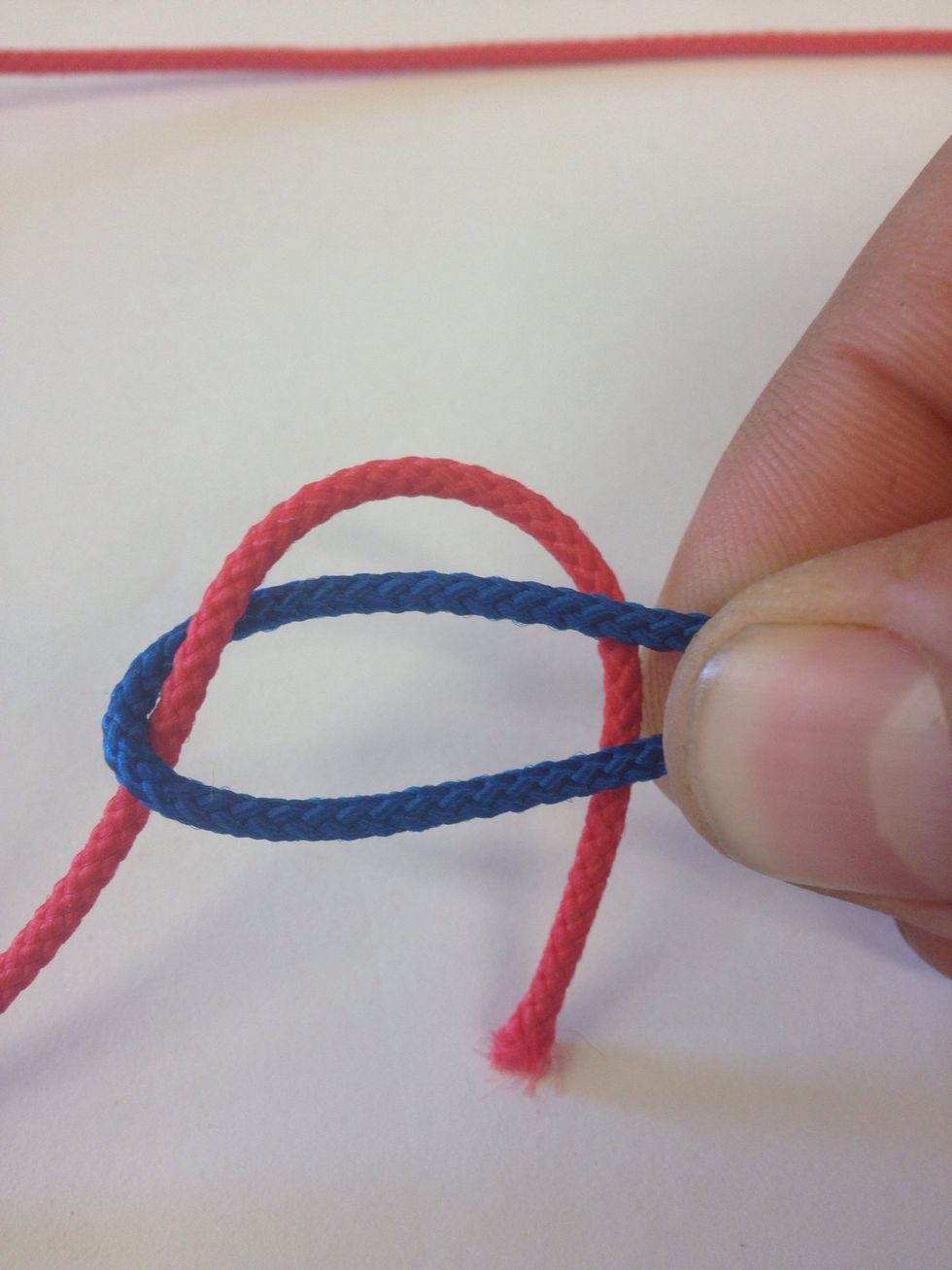 Take the other line (red) behind the loop and around.