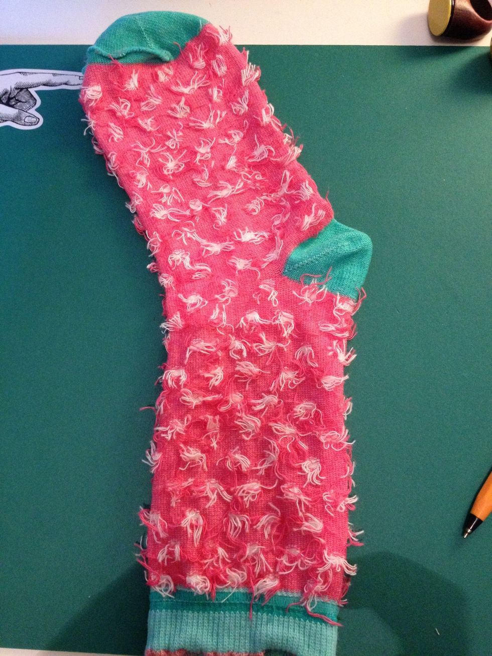 Take the other sock and lay it out flat. This will form the ears, mouth, arms and legs of the monkey.