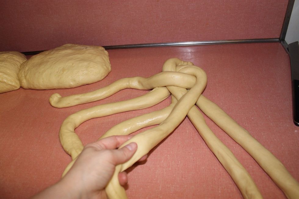 Take the outermost on the right and place it in the middle if the 4 inner strands, then go back to step 7 and keep repeating the steps until the dough is finished.