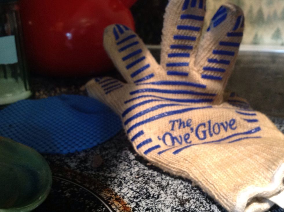 Take the oven mitt and slowly take the pan out of the oven.