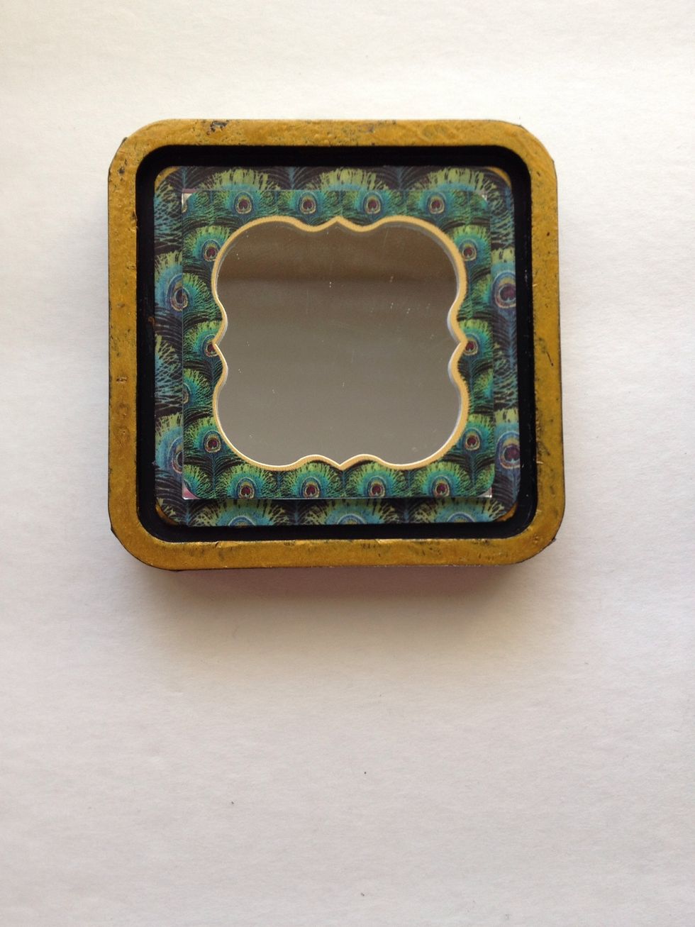 Take the peacock frame sticker from Step 17 and attach to the mirror.