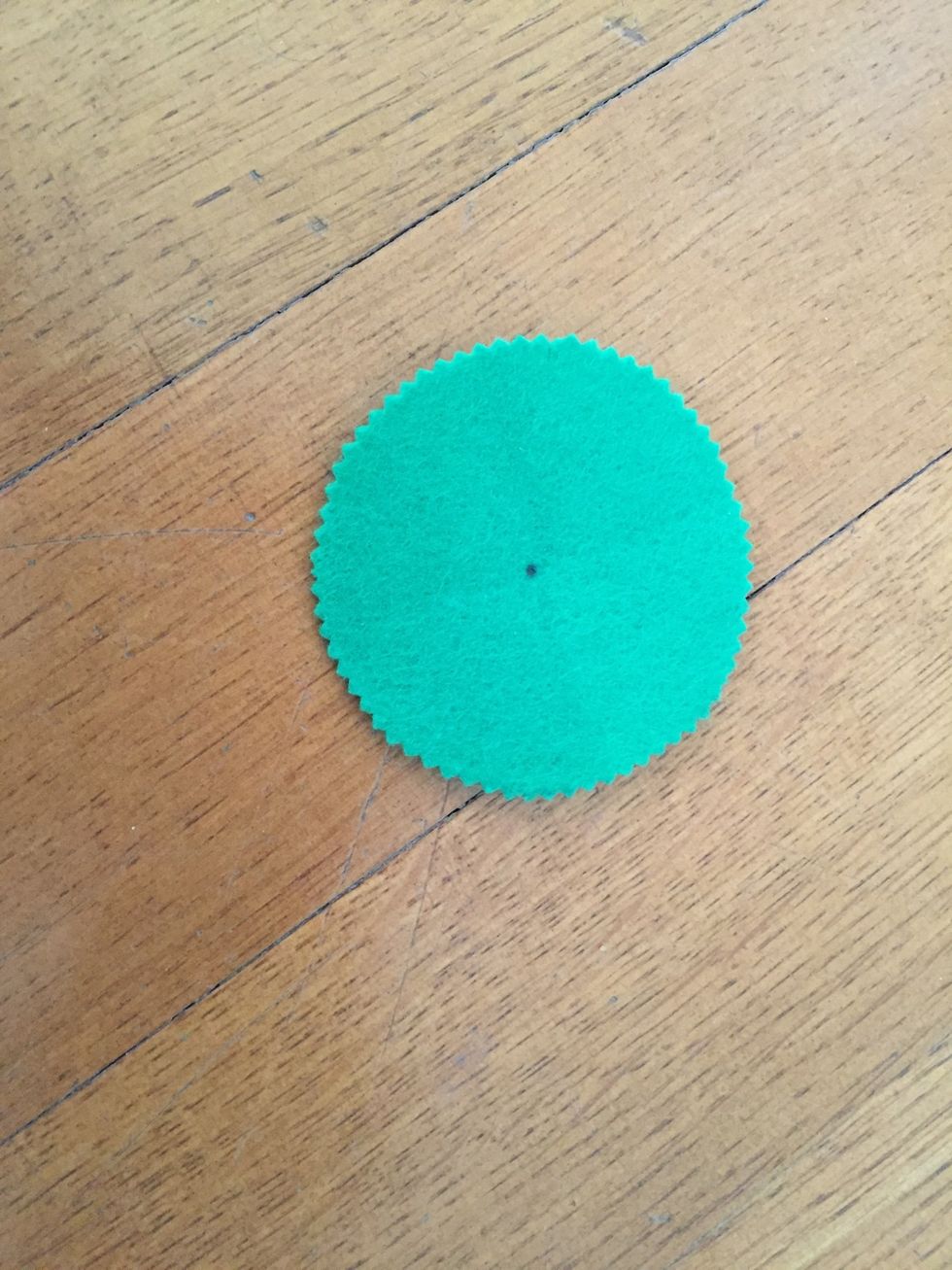 Take the pencil and make a dot approximately in the middle of the circle