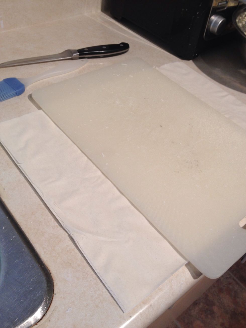 Take the phyllo dough. Spread it out. Use a cutting board as guide to cut straight. Cut depending on the size you want.