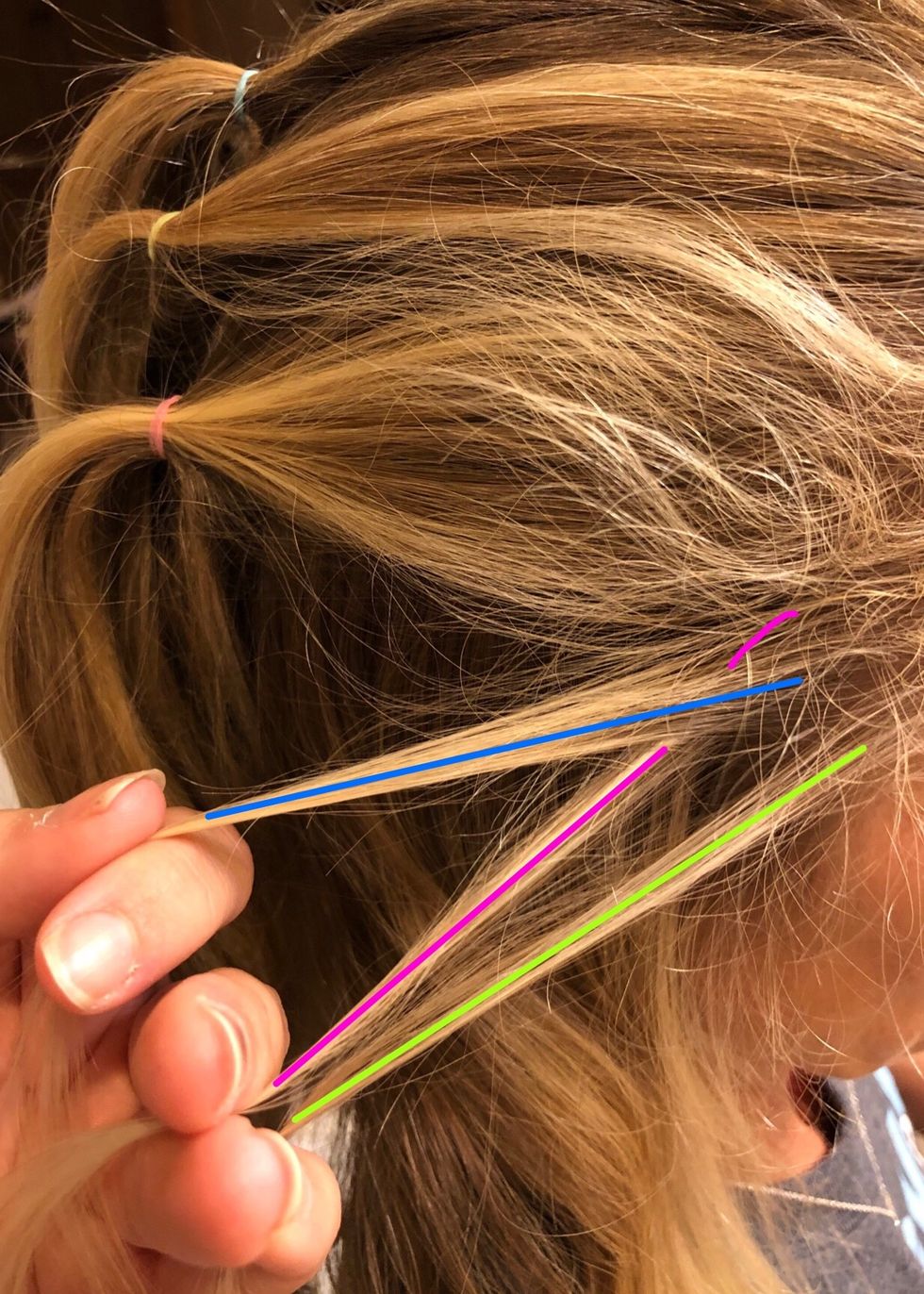 Take the pink (left) strand and cross in UNDERNEATH the blue (middle) strand.