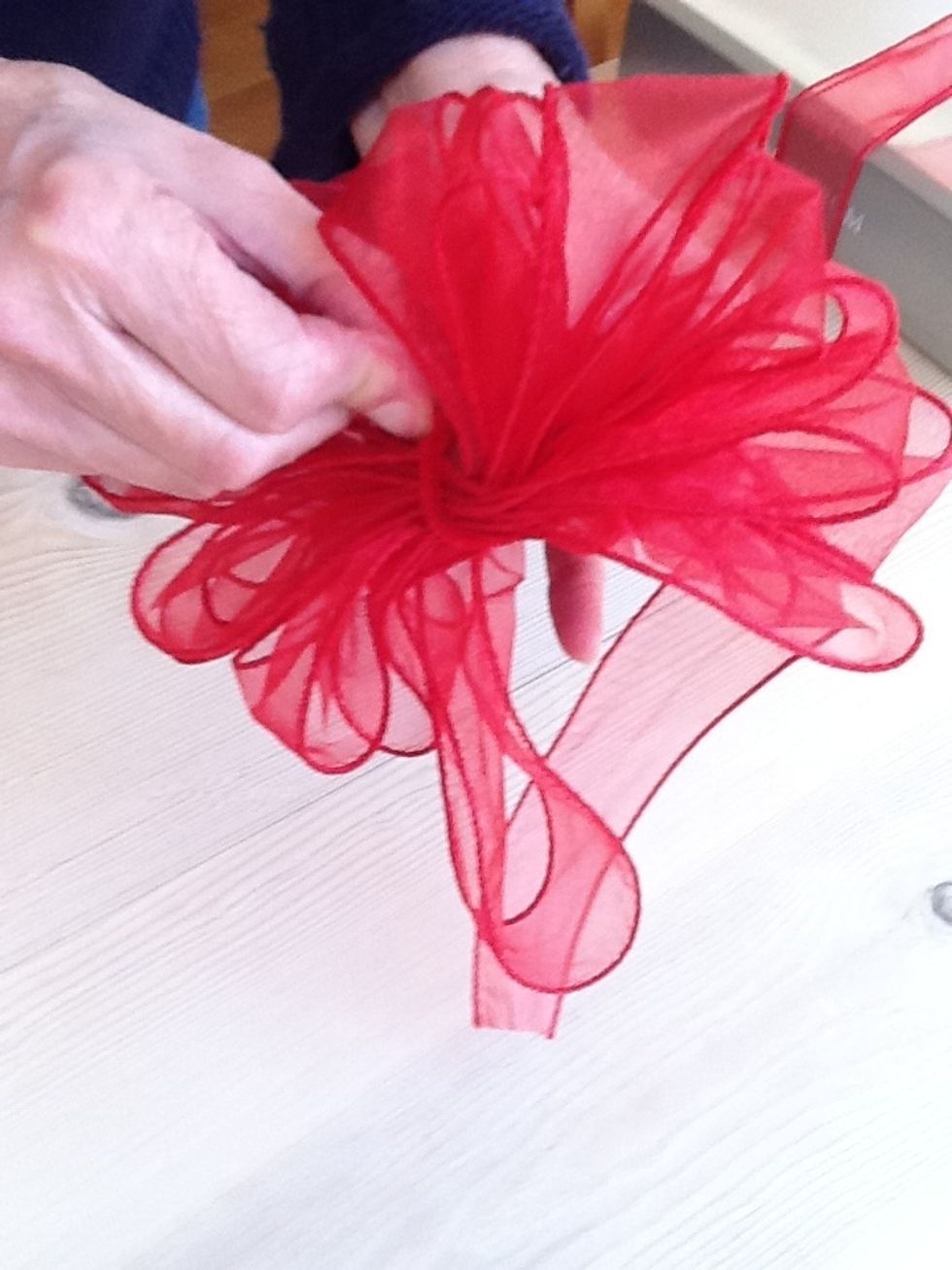 Take the pipe cleaner and twist it around the center as tightly as you can. Trim ithe pipe cleaner if necessary