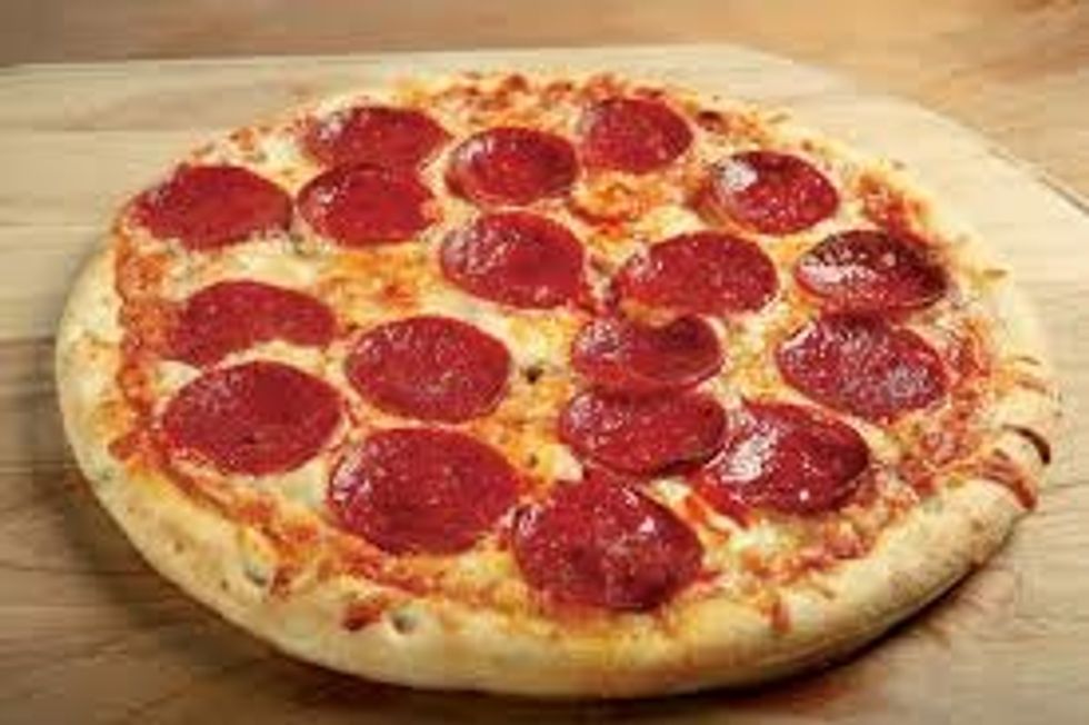 Take the pizza off the plate and put it on a cutting board. Cut the pizza into even triangles and put a slice on each plate. If there is still some left then put it back on the plate
