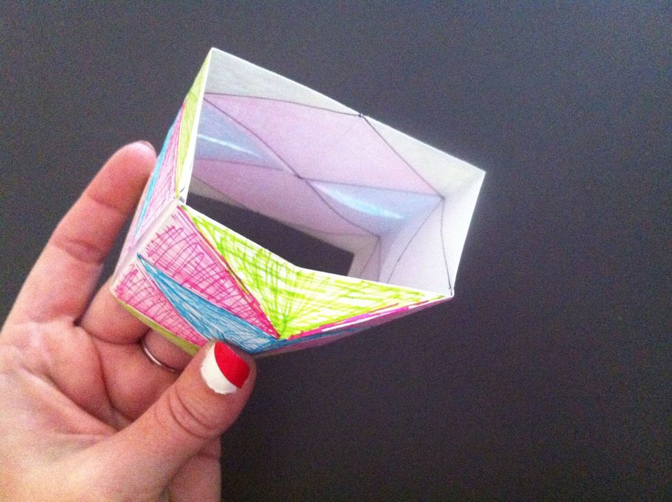 Take the point of triangle & push in. In my model it's the green area. Push in the other two green areas...