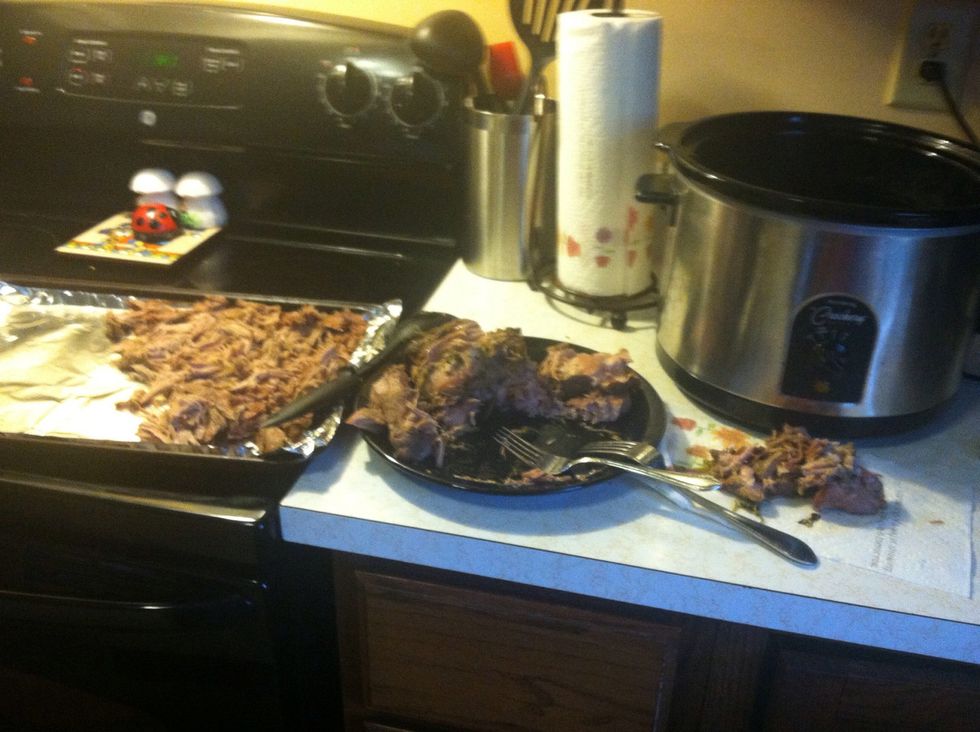 Take the pork and shred it with a fork, transfer it a baking sheet.
