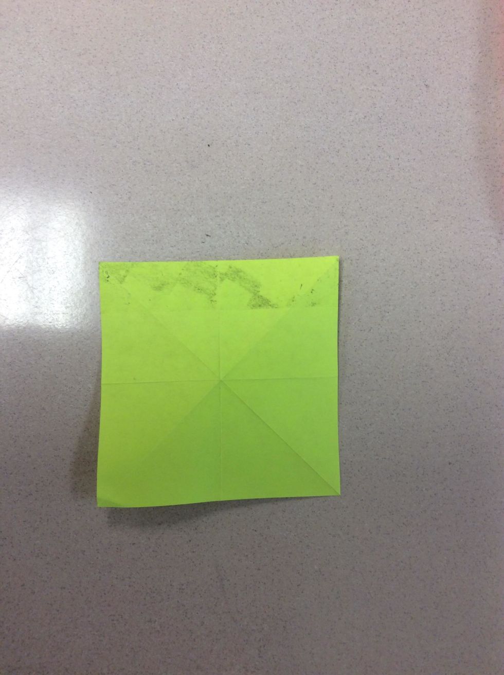 Take the Post-it note off the table or flat surface. Then turn it to the other side. You should see the sticky part.