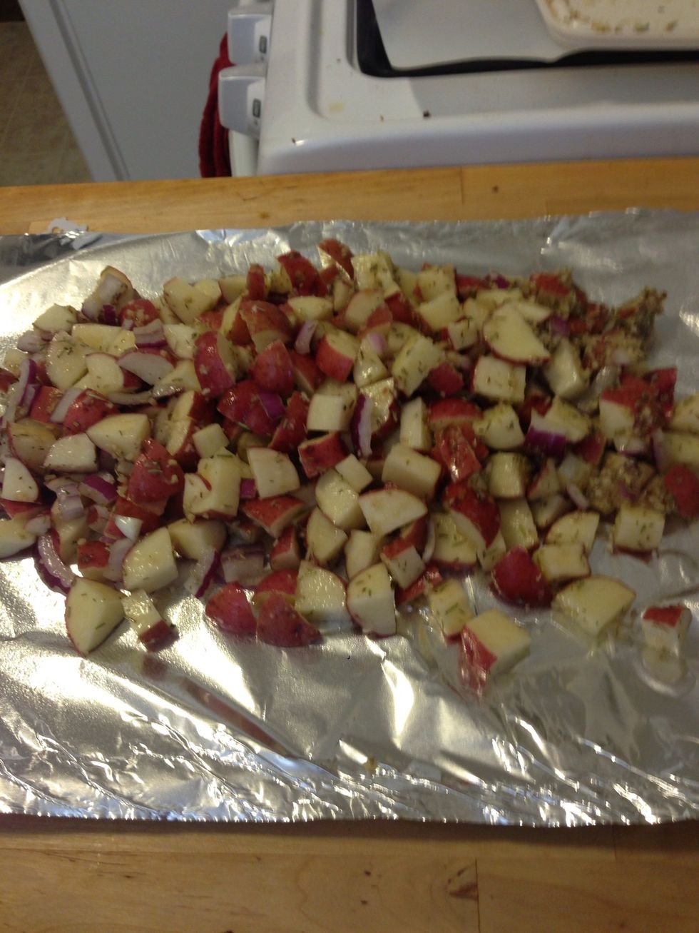 Take the potato mixture and evenly distribute on the tin foil.