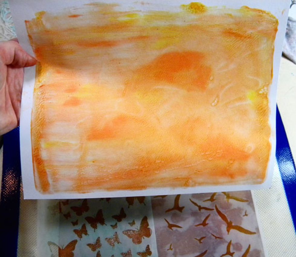 Take the print you just made and place it carefully down onto the plate, taking care not to move it around.  Use the brayer to  smooth the paper down and ensure even contact.