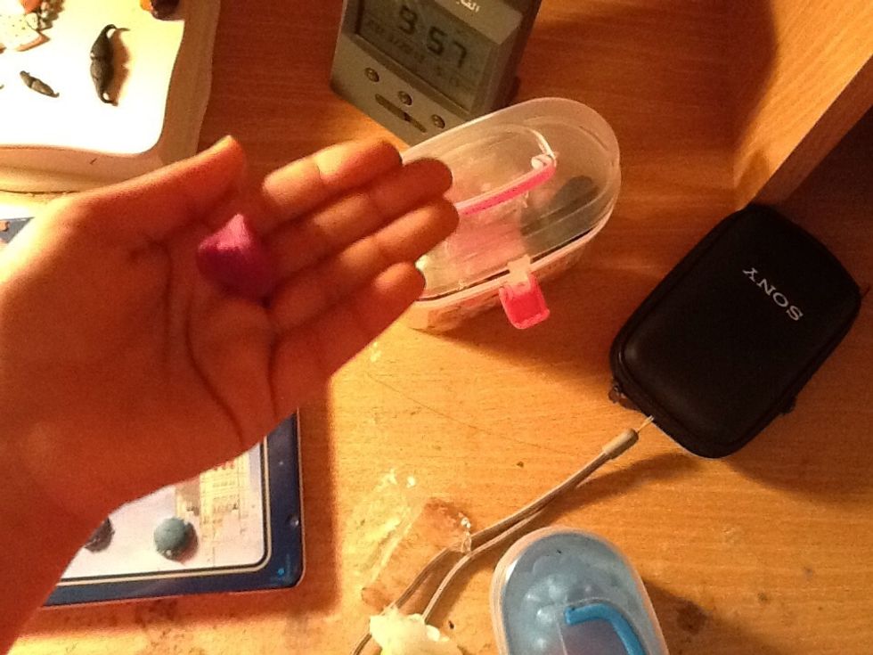 Take the purple clay and role it into a ball