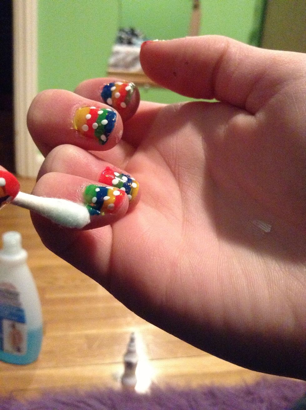 Take the q-tip and put nail polish remover on the tip. Clear up any polish off of your nail.