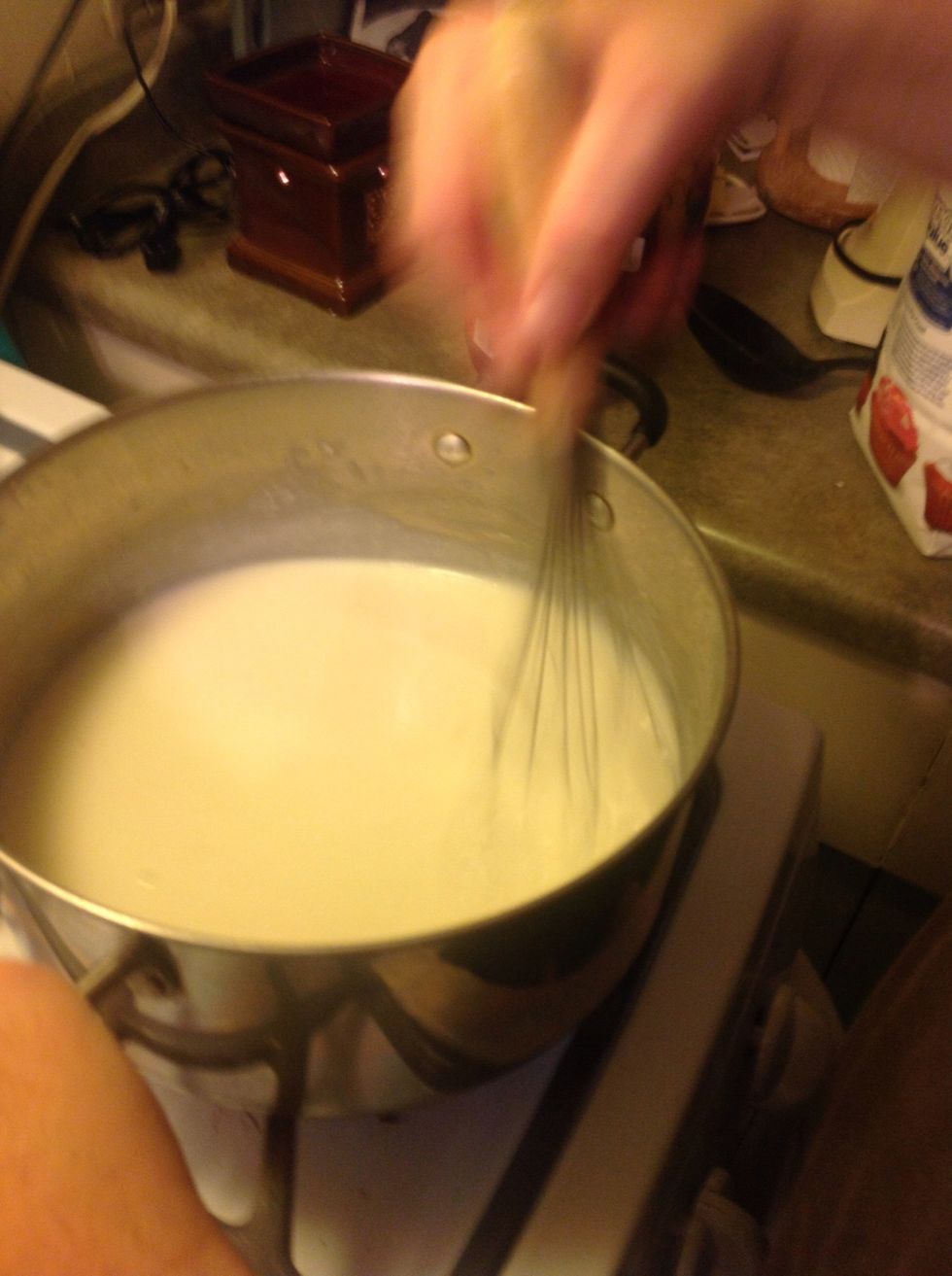 Take the remainder of your butter and melt it in a large pasta pot. Slowly add flour 1 TBLS at a time until it forms a paste. Make sure not to burn. Slowly add milk, stirring constantly. Will thicken.
