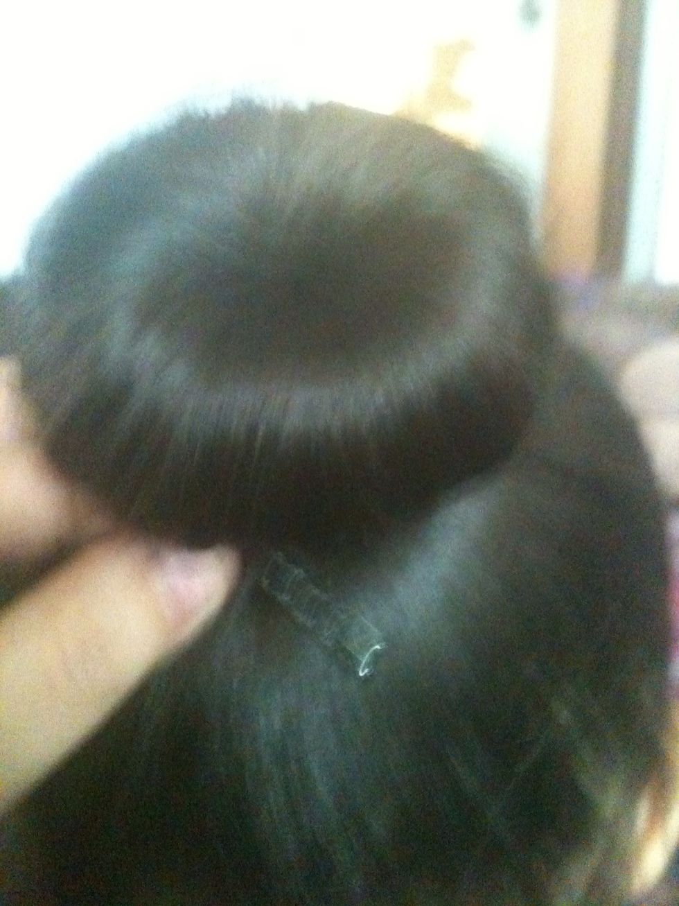 Take the rest of the hair and twist around the bun or just tuck it under then fasten with a bobby pin