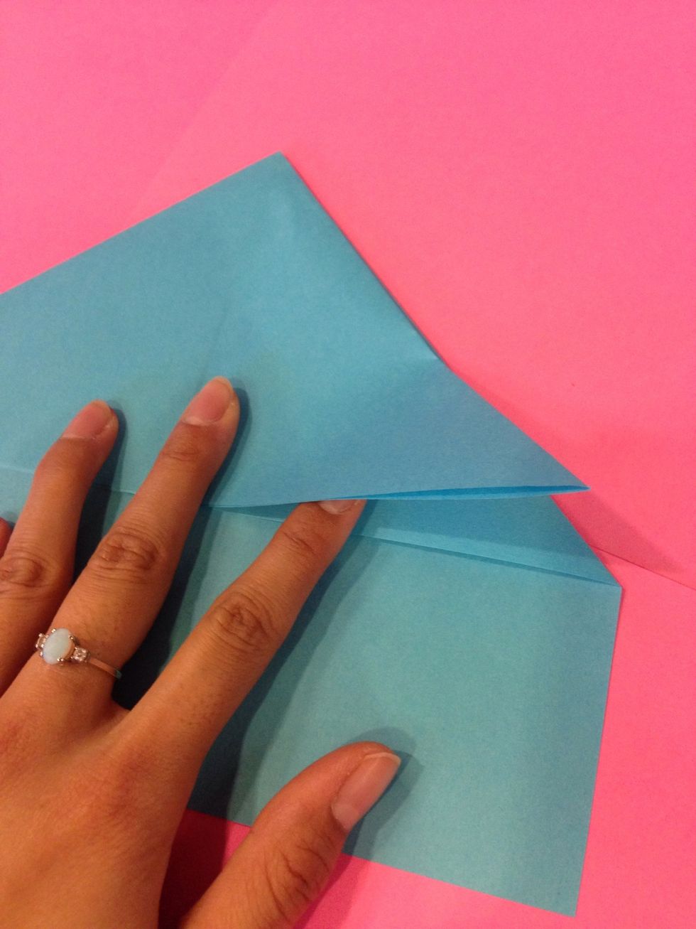 Take the right flap and fold it up making a triangle