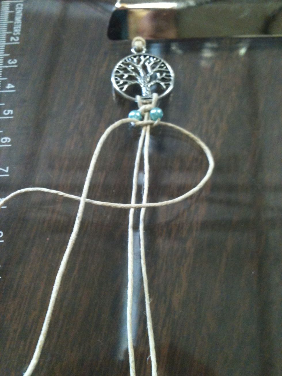 Take the right string and place it on top of the string that is attached to the pendant. Now take the left string and place it on top of the right string. Tuck the left string under the.. NEXT PAGE\ud83d\udc49
