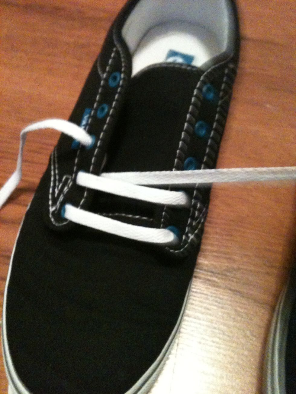 Take the right string and pull it through the top of the second eye on the left side