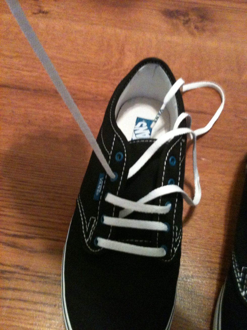 Take the right string (which is now on the left side) and pull it through the bottom of the left forth eye