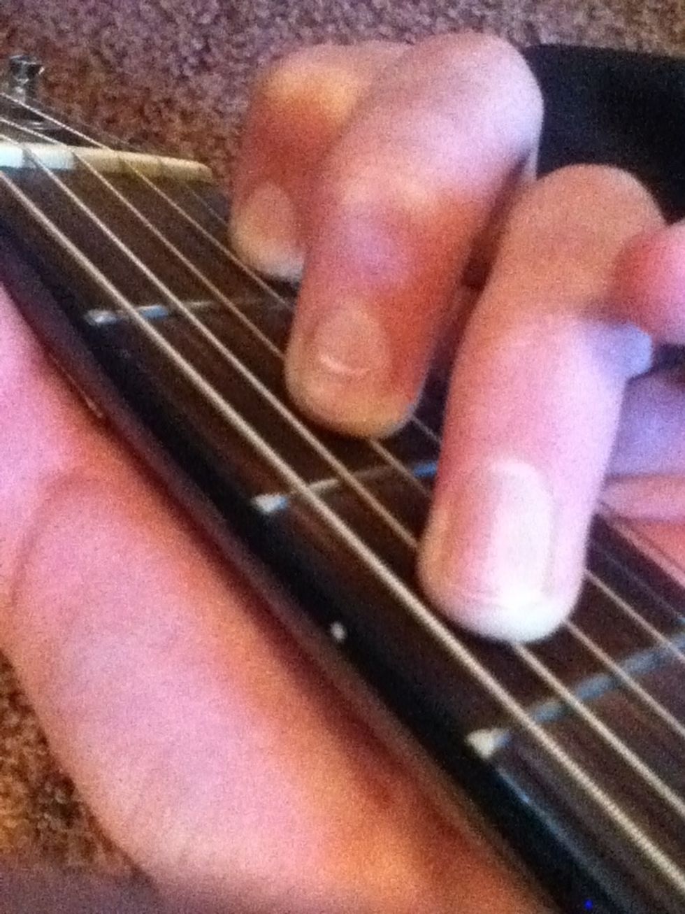 Take the ring and middle and move them up a string.