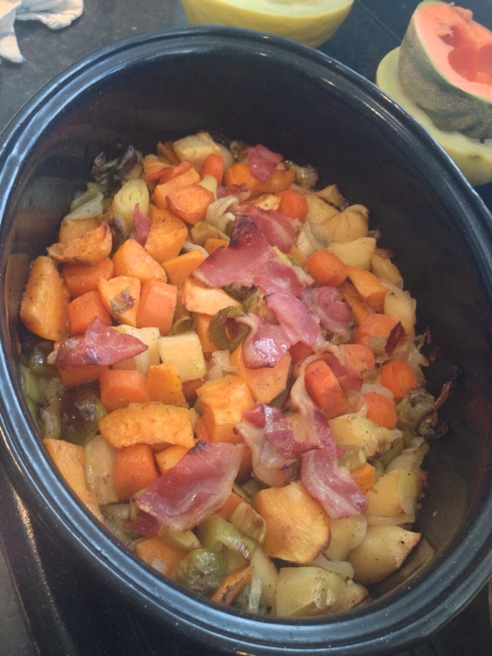 Take the roasted veg out of the oven and transfer it into a large pan to begin the gravy making