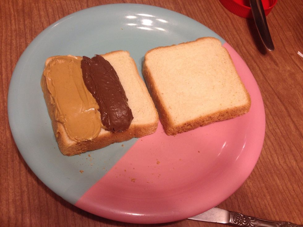 Take the same piece of bread and spread a strip of Nutella in the center.